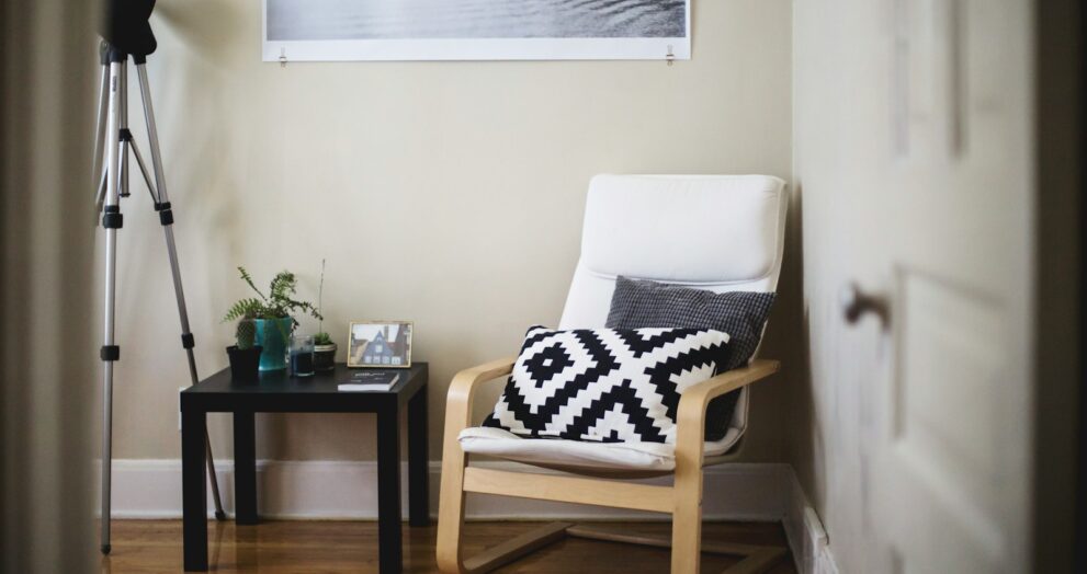throw pillow on chair beside end table inside room